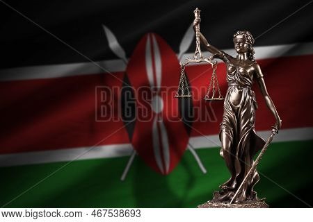 Kenya Flag With Statue Of Lady Justice And Judicial Scales In Dark Room. Concept Of Judgement And Pu