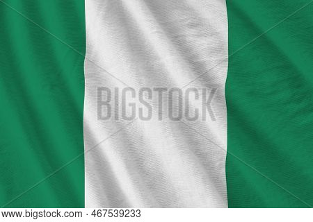 Nigeria Flag With Big Folds Waving Close Up Under The Studio Light Indoors. The Official Symbols And