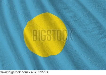 Palau Flag With Big Folds Waving Close Up Under The Studio Light Indoors. The Official Symbols And C