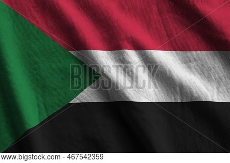 Sudan Flag With Big Folds Waving Close Up Under The Studio Light Indoors. The Official Symbols And C