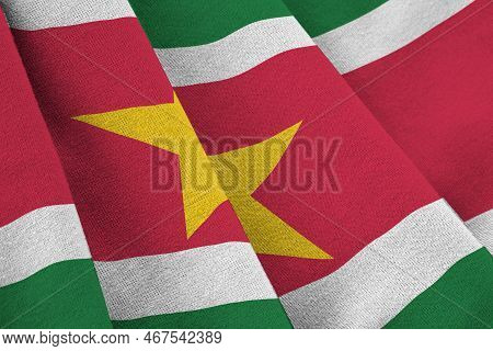 Suriname Flag With Big Folds Waving Close Up Under The Studio Light Indoors. The Official Symbols An
