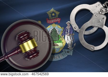 Maine Us State Flag With Judge Mallet And Handcuffs In Dark Room. Concept Of Criminal And Punishment