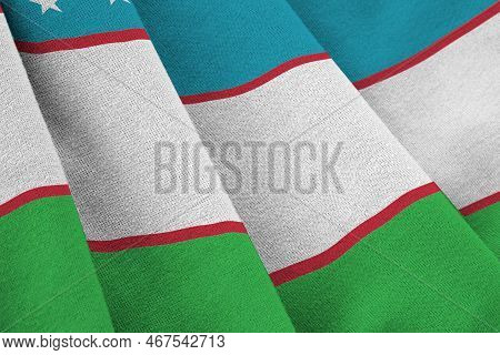 Uzbekistan Flag With Big Folds Waving Close Up Under The Studio Light Indoors. The Official Symbols 