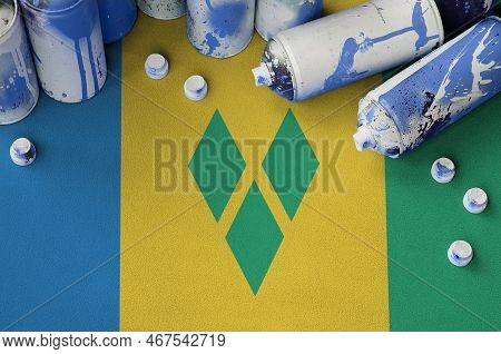 Saint Vincent And The Grenadines Flag And Few Used Aerosol Spray Cans For Graffiti Painting. Street 