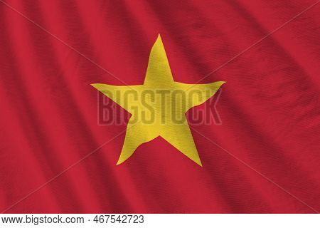 Vietnam Flag With Big Folds Waving Close Up Under The Studio Light Indoors. The Official Symbols And
