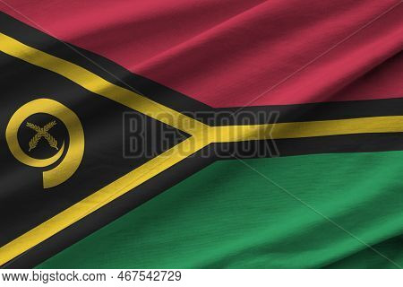 Vanuatu Flag With Big Folds Waving Close Up Under The Studio Light Indoors. The Official Symbols And