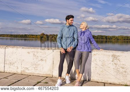Jogging Concepts. One Positive Runners  Couple Posing Together At River Bank Outside As Runners Duri