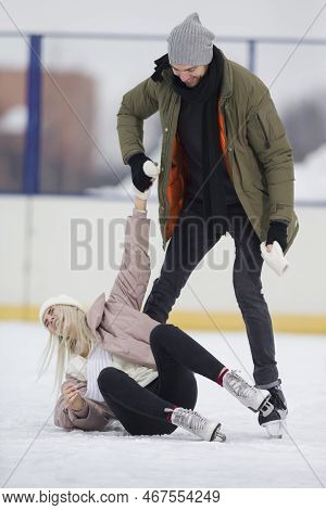 Youth Lifestyle. Young Caucasian Couple In Winter With Ice Skates Posing Together Over A Snowy Winte