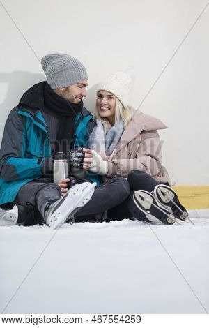 Winsome Happy Caucasian Couple In Love In Winter With Ice Skates Posing Together With Vacuum Flask I