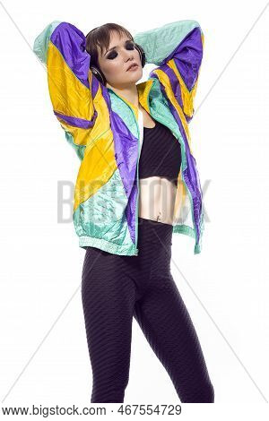 Relaxed Winsome Caucasian Female Athlete Sportwoman In Fitness Sexy Outfit Wearing Wireless Headphon