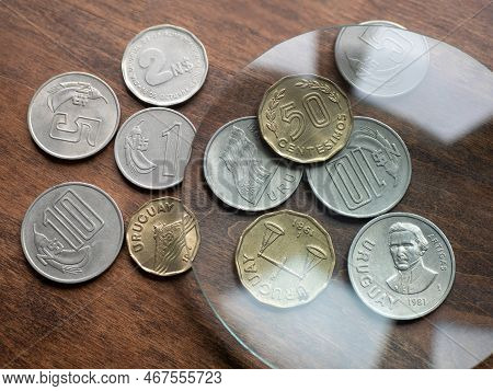 National Uruguayan Currency, Nuevos Peso And Centesimos Coin Money Of Uruguay Under Magnifying Glass