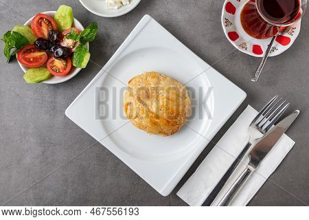Izmir Boyoz On A White Porcelain Plate On A Stone Table