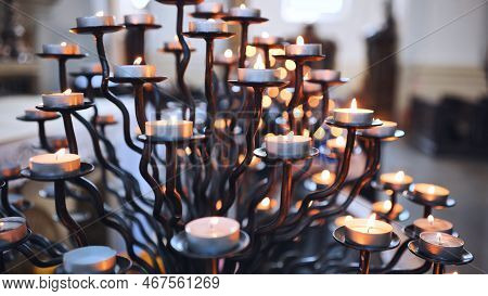 Candlestick Holder With Burning Candles In A Catholic Church.