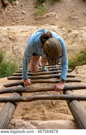 Visitor Climbs Ladder In Mesa Verde Ruins During A Summer Visit