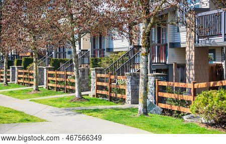 Wooden Front Yard Fence And Entrnace Of Residential Townhouses