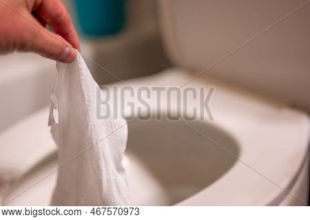 Disposable Wipes Being Flushed Down A Toilet Where They Can Cause Clogging And Problems With Wastewa
