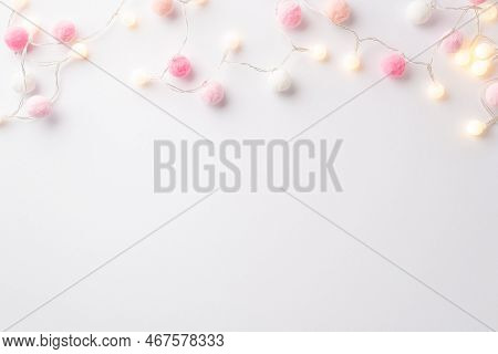 Saint Valentine's Day Concept. Top View Photo Of Light Bulb Garland And Soft Pompons On Isolated Whi