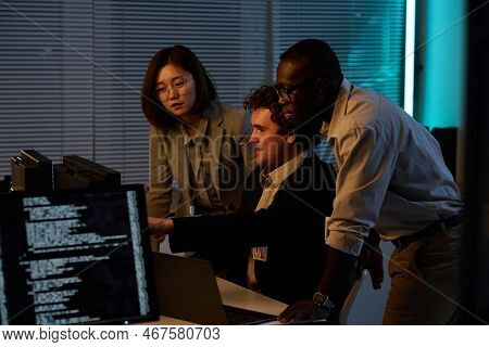 Group Of Developers Working With Computer Codes On Computer In Team Till Late At Night