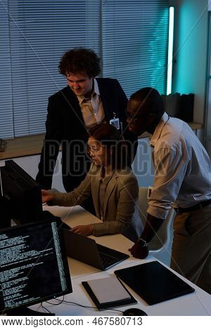 High Angle View Of Team Of Programmers Developing New Program On Computer During Their Work In Offic
