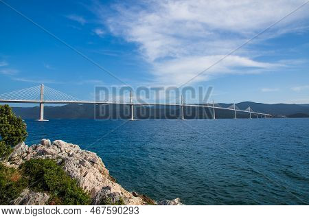 Beautiful Modern Bridge Over The Sea On Peljesac In Croatia. In The Foreground Houses And In The Bac