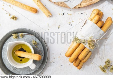 Breadsticks Grissini. Bread Sticks With Sesame Seeds, Oregano And Olive Oil And Balsamic Vinegar On 
