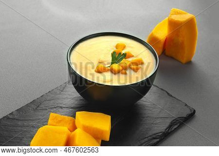 Pumpkin Cream Soup Mashed Potatoes On A Gray Background. Vegan Curried Pumpkin Lentil Soup Puree In 