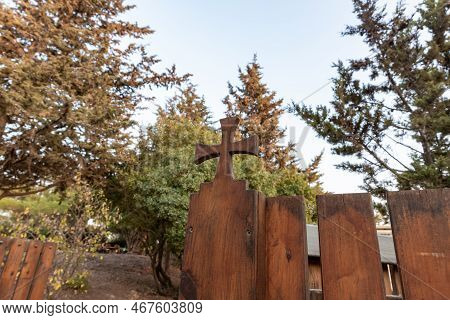 Hararit, Israel, October 28, 2022 : A Large Wooden Cross Carved From Wood On A Wooden Fence Around T