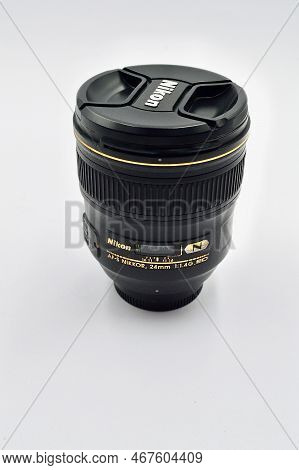 A Closeup Of A Nikon Lens Against A White Background