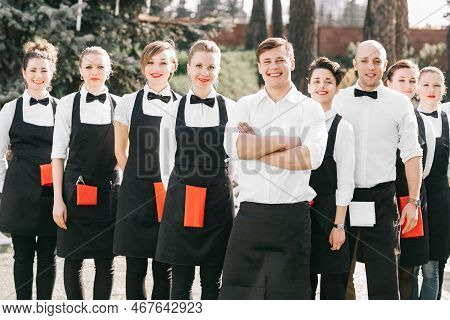Manager And A Group Of Young Hotel Staff Standing Together