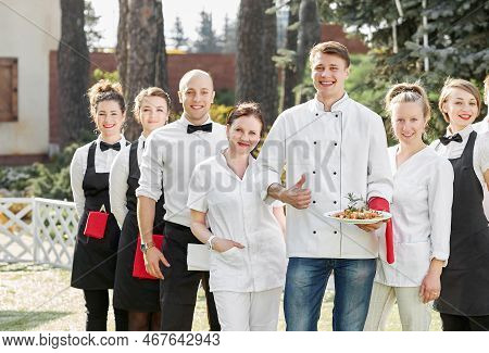 Restaurant Staff Standing Together And Showing Thumb Up.