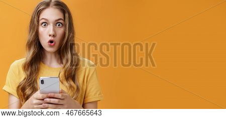 Close-up Shot Of Impressed Astonished Cute Young Girl With Makeup On And Natural Wavy Hair Folding L