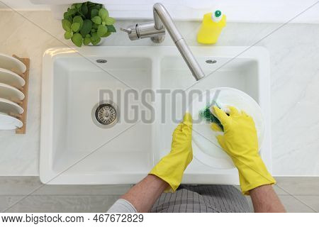 Man Washing Plate In Kitchen Sink, Top View