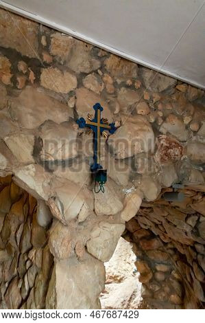 Hararit, Israel, October 28, 2022 : Decorative Cross Attached To The Wall Of The Cave Church - Lavra