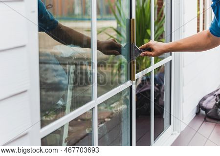 Worker Use Scraper Cleaning Window Before Installing Tinting Film