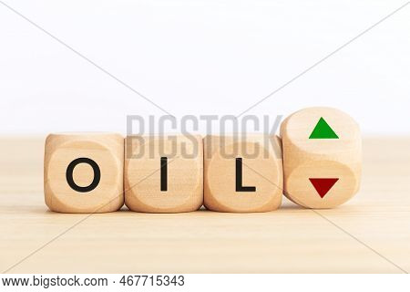 Oil Price Up Or Down Concept. Text On Wooden Blocks And Turning Dice With Up And Down Arrows. Copy S