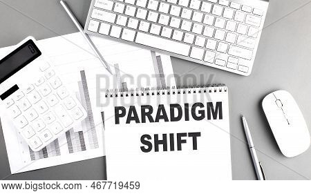 Paradigm Shift Text Written On Notebook On A Grey Background With Chart And Keyboard, Business Conce