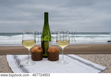 Sweet Fruit Christmas And New Year Cake Panettone With Two Glasses Of Txakoli White Wine Served On S