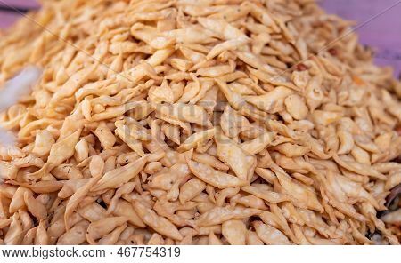 Closeup Of Nimki Or Salted Namak Para Indian Crunchy Savoury Snack Heap With Selective Focuc On Fron