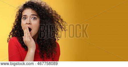 Close-up Shot Of Concerned And Shocked Worried Woman With Curly Hairstyle Open Mouth Wide And Coveri