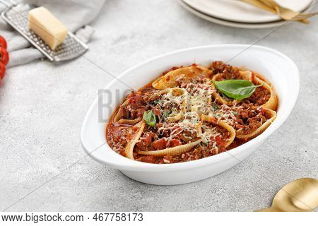 Pasta Stuffed With Bolognese Meat Sauce, Tomatoes, Cheese, Basil In Baking Dish. Italian Bolognese P