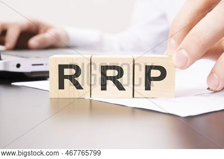 Wooden Blocks With Rrp Text - On Table Background. Financial, Marketing And Business Concepts