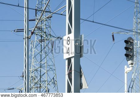 Rail Signal, Catenary Overhead Line, Power Transmission Line Tower Sunlit Against Blue Sky