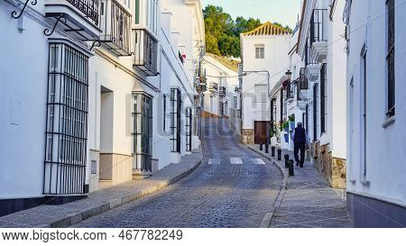 Man Walking Through The Narrow Streets Of The White And Picturesque Village Of Medina Sidonia, Cadiz