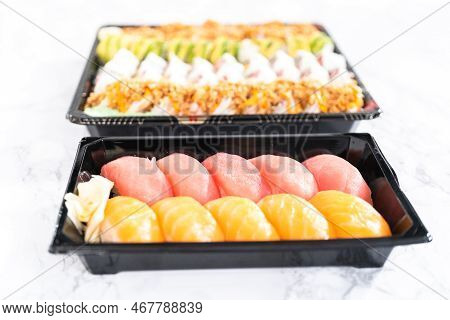 Pre-packaged Variety Of Sushi And Sushi Rolls In A Plastic Tray.