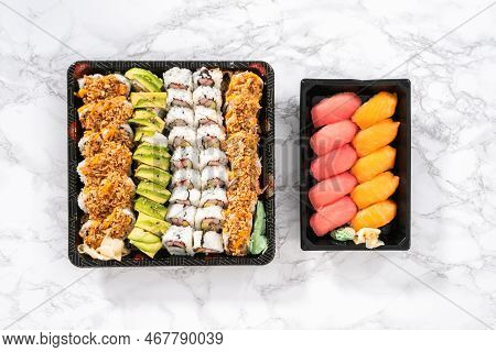 Flat Lay. Pre-packaged Variety Of Sushi And Sushi Rolls In A Plastic Tray.