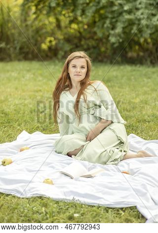 Young Pretty Pregnant Woman Resting In Park, Lying On Cover, Blanket In Park, Meadow, Enjoying Pregn
