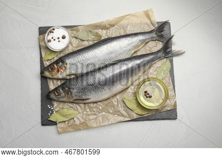 Slate Plate With Salted Herrings, Oil And Spices On Grey Table, Top View