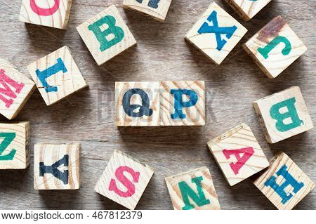 Alphabet Letter Block In Word Qp (abbreviation Of Quality Procedure) And Another Letter On Wood Back