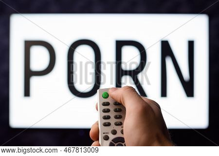 Young Man Wants To Watch Pornography Film And Enjoy Himself Turns On A Tv Set By Pressing Green Butt