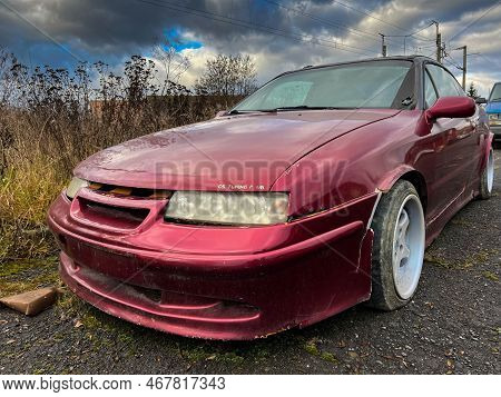 Miercurea Ciuc, Romania- 25 December 2022: Old Abandoned Opel Calibra In Very Bad Condition Near Roa